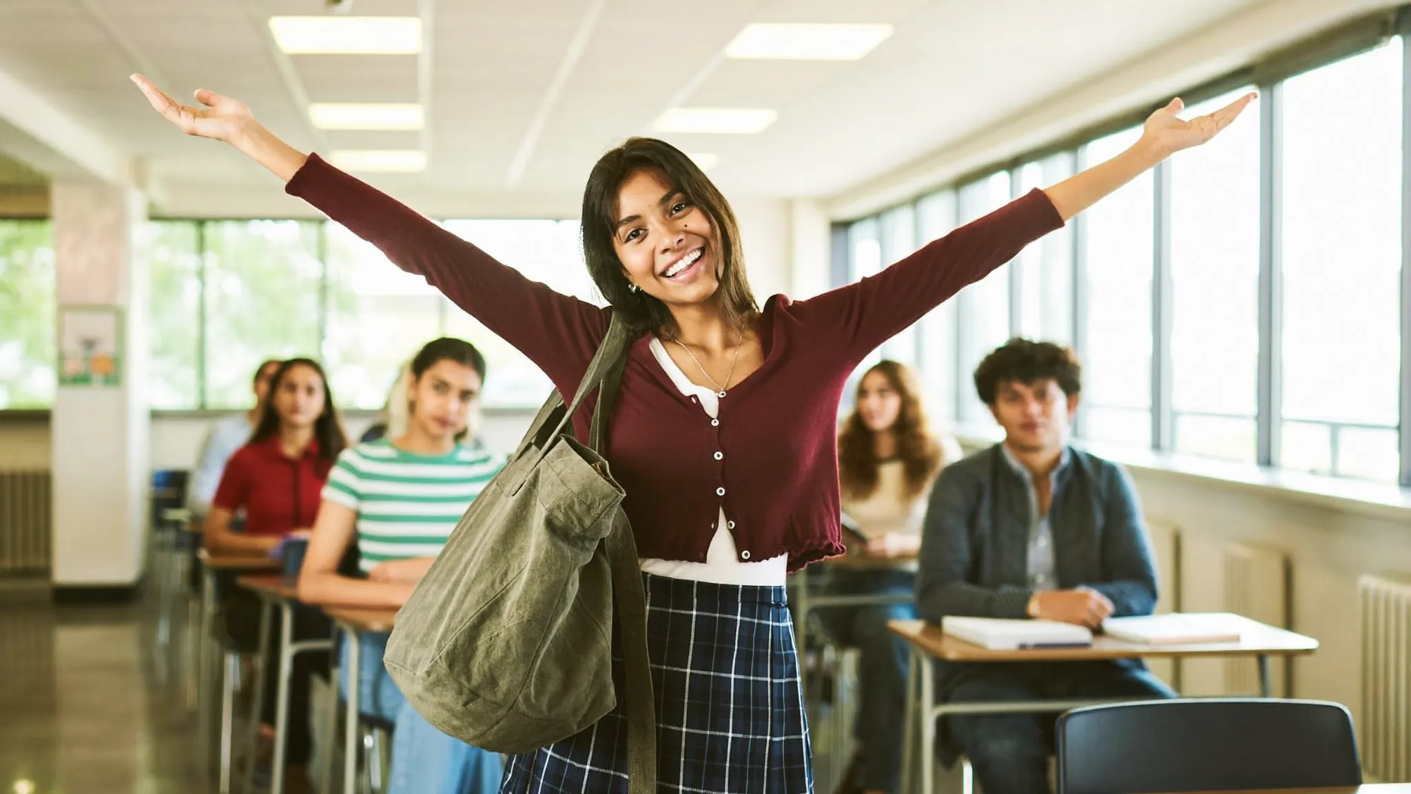 A confident Indian college student giving a self-introduction in a bright classroom — HireFresher